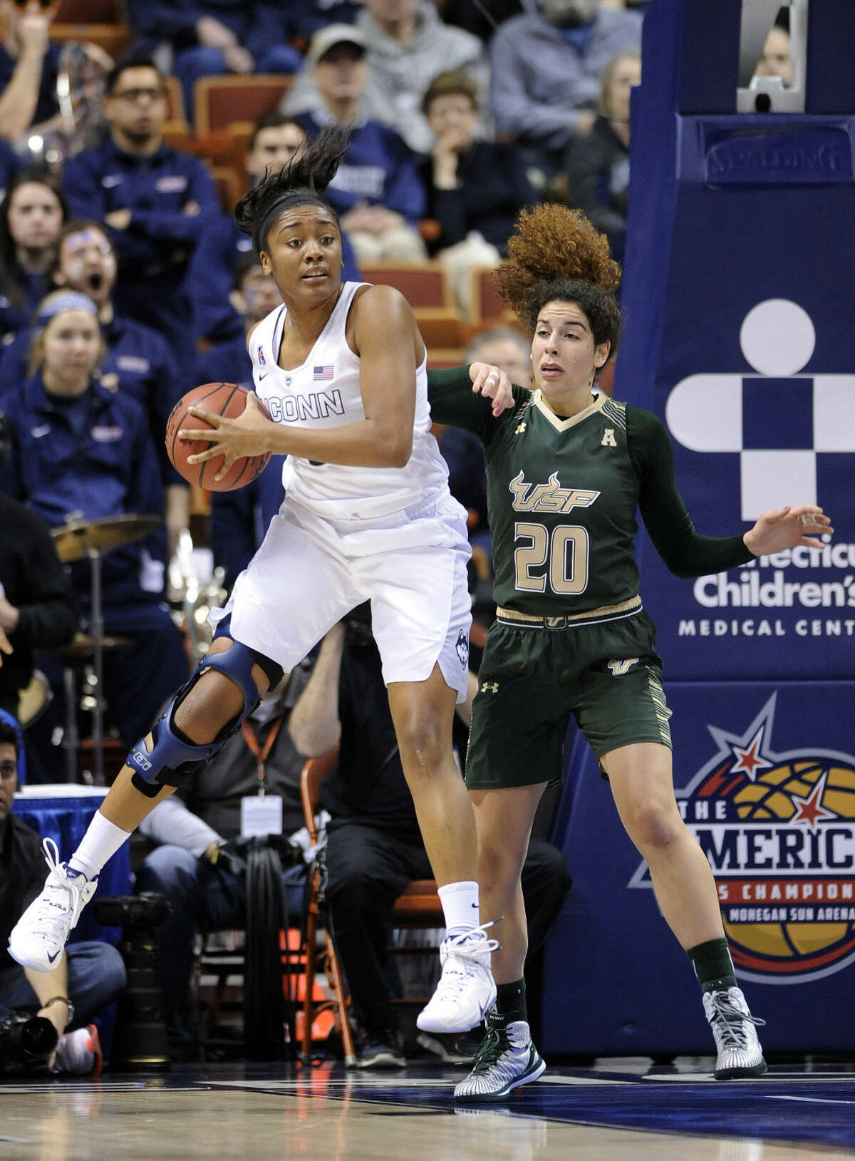 Connecticut's Morgan Tuck grabs a rebound from USF's Laura Ferreira (20) during the first half of an NCAA college basketball game in the finals of the American Athletic Conference tournament in Uncasville, Conn., on Monday, March 9, 2015. (AP Photo/Fred Beckham)
