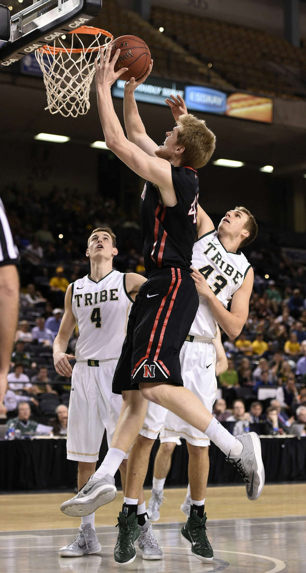 Northeastern's Scott Eatherton, left, shoots as William and Mary's Tom Schalk tries to block in the half of an NCAA college basketball game in the CAA Championship basketball tournament Monday, March 9, 2015, in Baltimore. (AP Photo/Gail Burton)