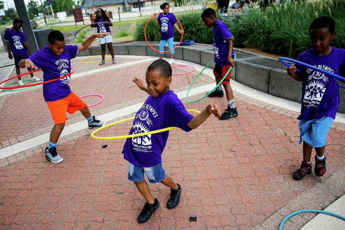 Ardyn Harrison, 7, ﻿and other children play with hula hoops Friday during the opening ceremonies of the 30th annual Harris County Precinct ﻿1 Street Olympics at Mickey Leland Memorial Park﻿. The event was a signature program of the late Harris County Commissioner El Franco Lee, whose widow, Kaye Lee, ﻿this week endorsed state Sen. Rodney Ellis for her late husband's seat.