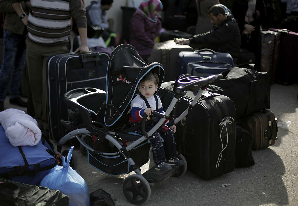 Palestinians wait with their luggage to cross the border into Egypt, at the Rafah crossing in the southern Gaza Strip, Monday, March 9, 2015. Egypt has temporarily opened a crossing with the Gaza Strip for the first time in nearly two months. The Rafah crossing was opened Monday for two days for students, patients seeking medical care and dual nationals. It was the first time it was opened since an Egyptian court declared the territory's rulers, Hamas, a terrorist organization. (AP Photo/Khalil Hamra)