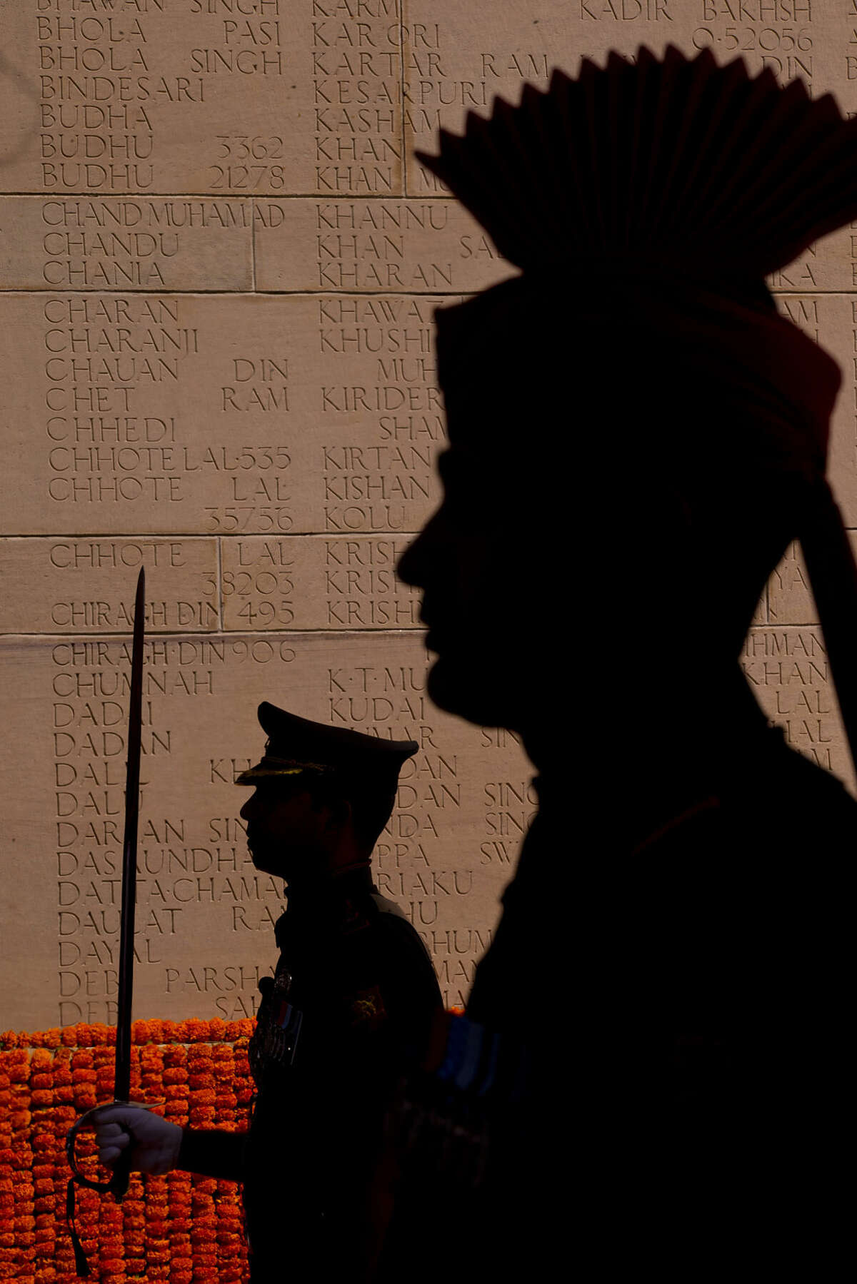 Indian soldiers pay homage as they stand near names of soldiers inscribed on the wall at the India Gate war memorial, in New Delhi, India, Monday, March 9, 2015. The Indian Army will organize a series of events beginning Monday to commemorate the valor and sacrifice of Indian soldiers who fought in the First World War. (AP Photo/Saurabh Das)