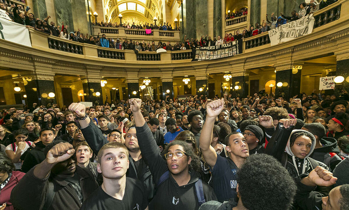 Demonstrators protest the shooting of Toly Robinson at the state Capitol Monday, March 9, 2015, in Madison, Wis. Robinson, 19, was fatally shot Friday night by a police officer who forced his way into an apartment after hearing a disturbance while responding to a call. Police say Robinson had attacked the officer. (AP Photo/Andy Manis)