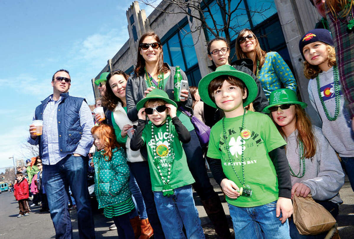 Hour photo / Erik Trautmann Area residents line the streets for The Stamford St. Patrick’s Day Parade as it follows last year’s parade route proceeding North on Atlantic Street and continuing onto Bedford Street Saturday.