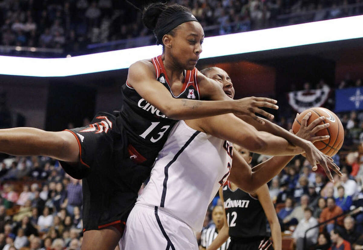 Cincinnati's Brandey Tarver, left, fouls Connecticut's Kaleena Mosqueda-Lewis, right, during the first half of an NCAA college basketball game in the quarterfinals of the American Athletic Conference women's basketball tournament, Saturday, March 8, 2014, in Uncasville, Conn. (AP Photo/Jessica Hill)