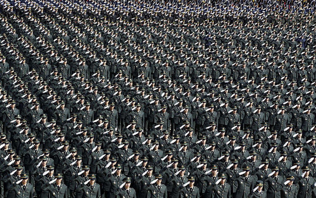 New South Korean military officers salute during the joint commission ceremony of over 6,000 new military officers of the army, navy, air force and marines at the military headquarters in Gyeryong, south of Seoul, South Korea, Thursday, March 12, 2015. (AP Photo/Lee Jin-man)