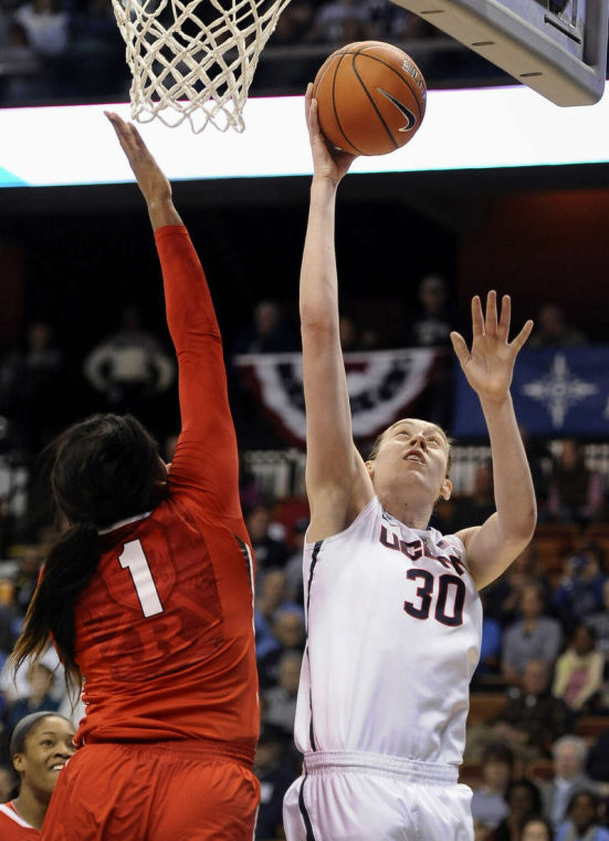 Connecticut's Breanna Stewart, right, scores as Rutgers' Rachel Hollivay, left, defends during the first half of an NCAA college basketball game in the semifinals of the American Athletic Conference women's tournament, Sunday, March 9, 2014, in Uncasville, Conn. (AP Photo/Jessica Hill)