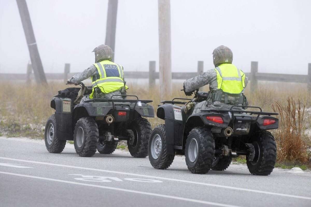 Unidentified military personnel ride all-terrain vehicles at Navarre Beach, Fla., Wednesday, March 11, 2015 as they search for survivors from an Army Black Hawk helicopter that went down near this Florida panhandle community Tuesday evening with 11 service members aboard. (AP Photo/Northwest Florida Daily News, Devon Ravine)