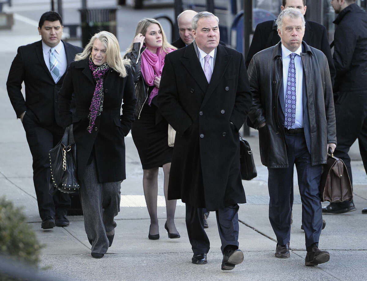 Former Connecticut Gov. John Rowland, center, arrives with wife Patty, left, and attorney Reid Weingarten, right, at federal court in New Haven, Wednesday, March 18, 2015, in New Haven, Conn. A federal court jury in New Haven convicted Rowland in September of federal charges that he conspired to hide payment for work on two congressional campaigns. His sentencing on Wednesday will come 10 years to the day that he was sentenced to a year and a day in prison for accepting illegal gifts while in office, including trips and improvements to his lakeside cottage. (AP Photo/Jessica Hill)