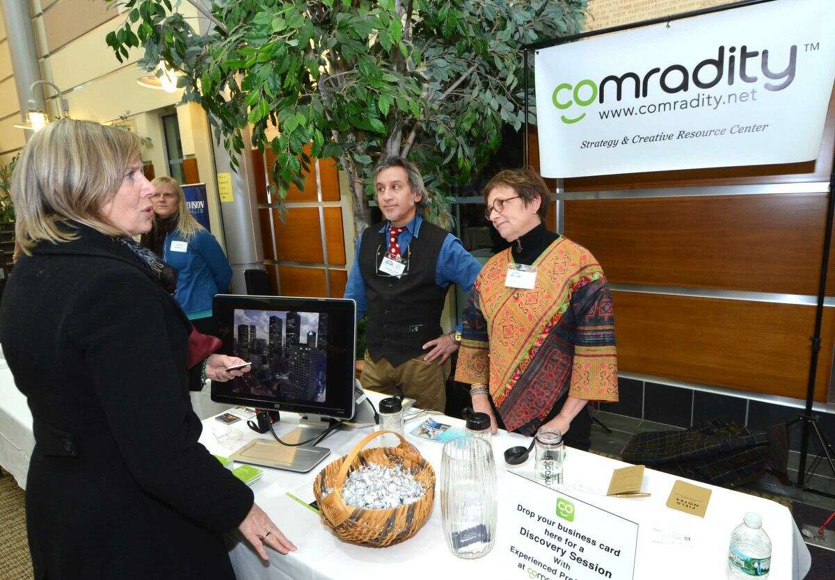 Hour Photo/Alex von Kleydorff Comradity, Strategy and Resource Center personnel talks with visitors at the 2015 Multi Chamber Expo and Networking Event at NCC