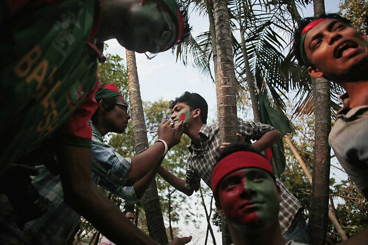 A Bangladeshi cricket fan has his face painted in the colors of his national flag during a show of support to their national team at the Dhaka University Campus in Dhaka, Bangladesh, Wednesday, March 18, 2015. Bangladesh will play the World Cup quarterfinal match against India on Thursday. (AP Photo/ A.M. Ahad)