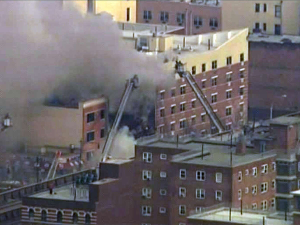 In this image taken from video from WABC, firefighters battle a blaze at the site of a possible explosion and building collapse in the East Harlem neighborhood of New York, Wednesday, March 12, 2014. (AP Photo/WABC-TV)