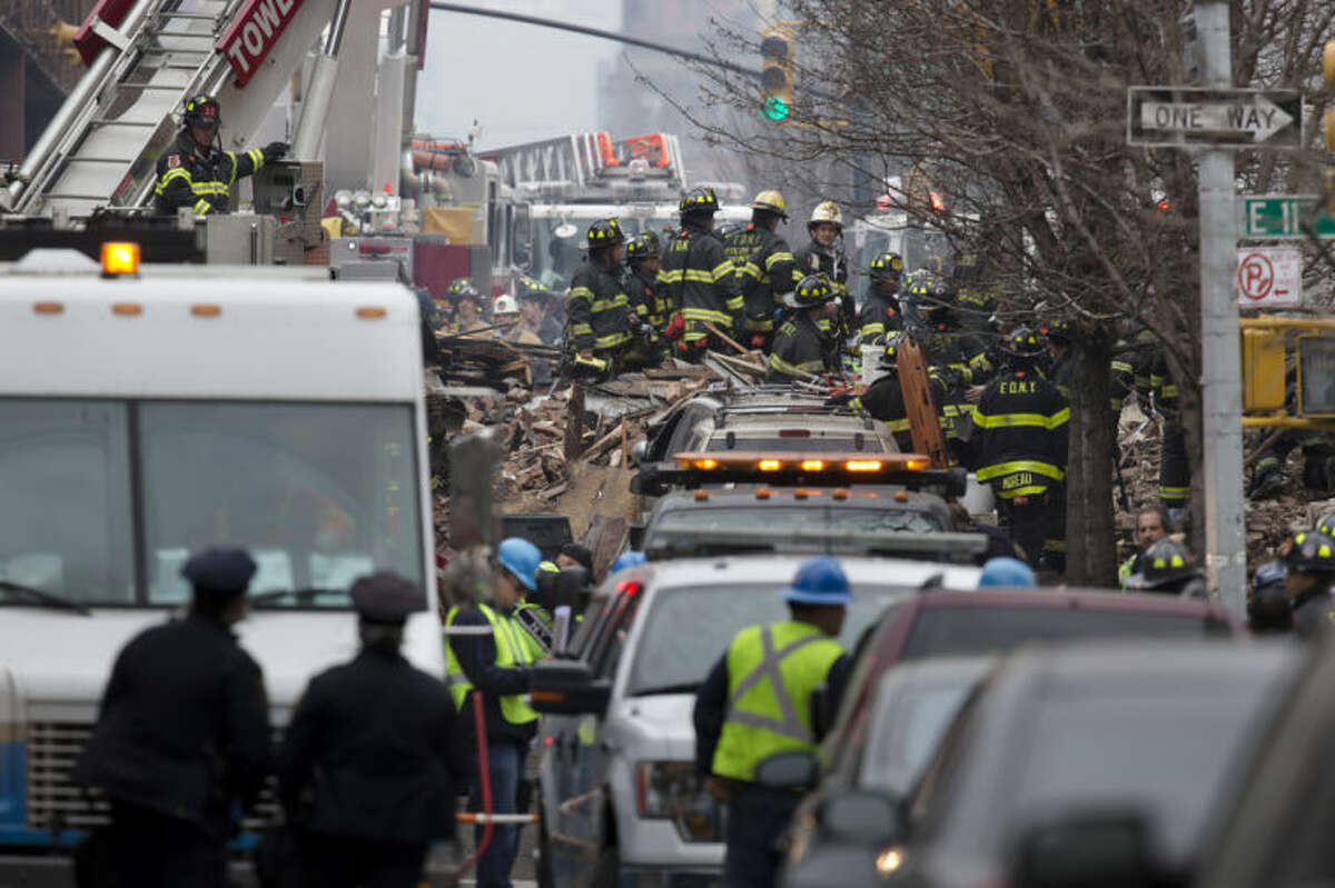 Firefighters respond to an explosion that leveled two apartment buildings in the East Harlem neighborhood of New York, Wednesday, March 12, 2014. Con Edison spokesman Bob McGee says a resident from a building adjacent to the two that collapsed reported that he smelled gas inside his apartment, but thought the odor could be coming from outside. (AP Photo/John Minchillo)