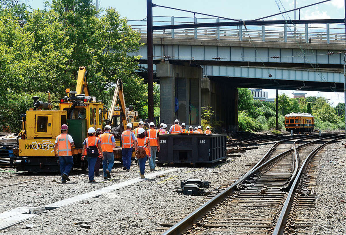 Hour photo / Erik Trautmann Officials with the engineering firm HNTB Corp and Metro North Railroad inspect Metro-North’s Danbury Line near Science Rd and Crescent St Thursday. The State Bond Commission last month appproved $4 million for project and Norwalk’s legislative delegation in Hartford on Wednesday asked U.S. Department of Transportation secretary to support Connecticut's request for $12 million in federal funds for the project.