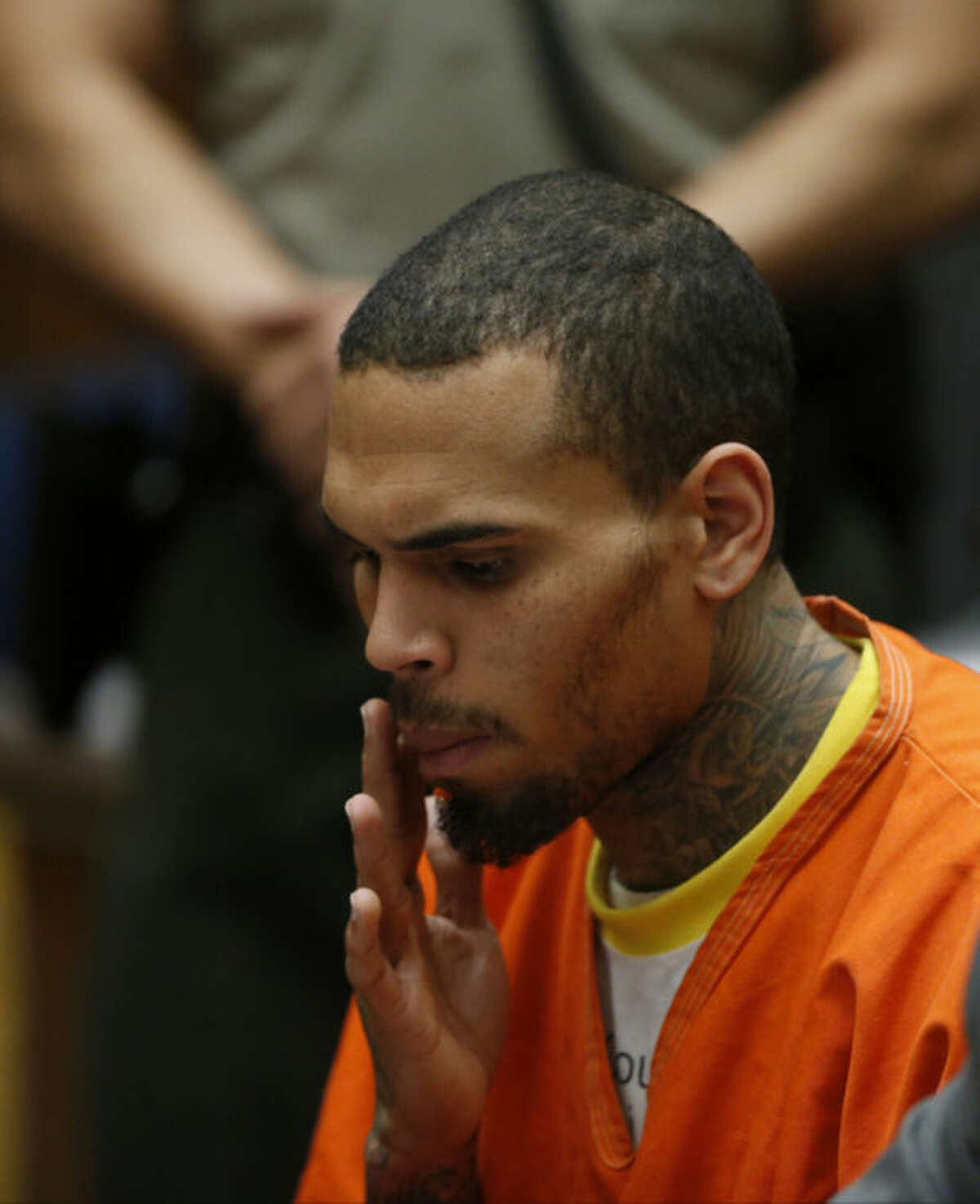 R&B singer Chris Brown appears in Los Angeles Superior Court with his attorney Mark Geragos, on Monday, March 17, 2014. Brown will spend another month in jail after a judge said Monday he was told the singer made troubling comments in rehab about being good at using guns and knives. The singer was arrested on Friday, March 14, 2014, after he was dismissed from a Malibu facility where he was receiving treatment for anger management, substance abuse and issues related to bipolar disorder. (AP Photo/Lucy Nicholson, Pool)