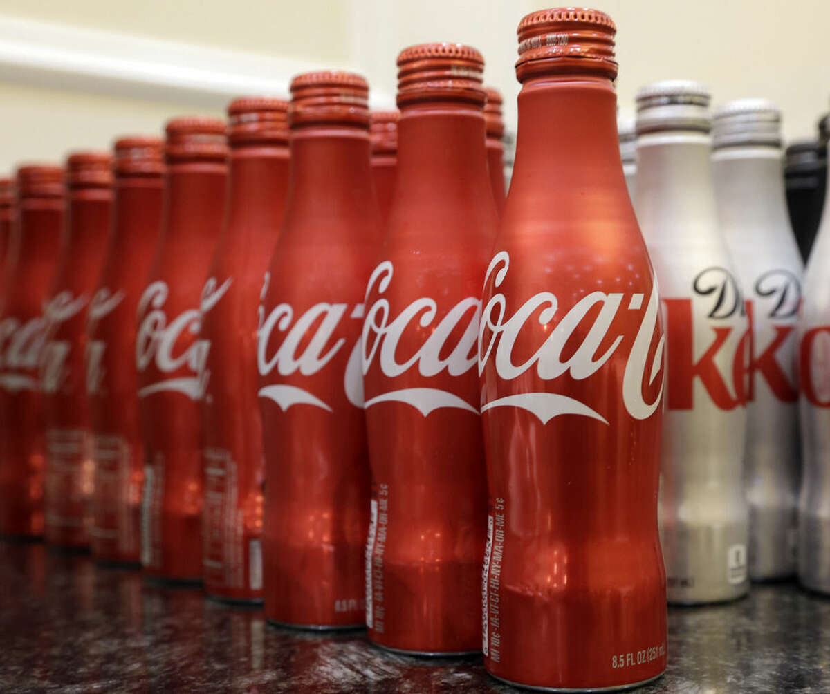 This March 7, 2015 photo shows 8.5 ounce bottles of Coca-Cola at the Cadillac Championship golf tournament in Doral, Fla. Coca-cola, which struggles with declining soda consumption in the U.S., is working with fitness and nutrition experts who suggest its cola as a healthy treat. (AP Photo/Wilfredo Lee)