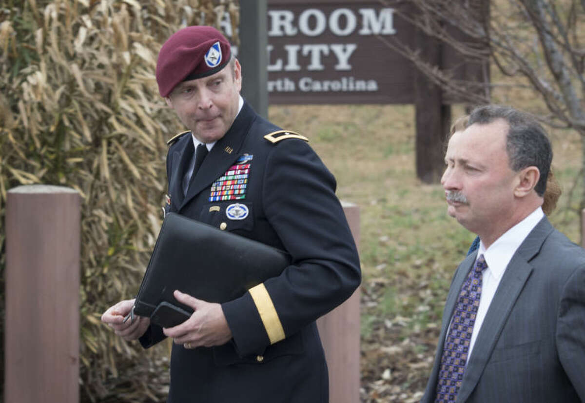 Brig. Gen. Jeffrey Sinclair, left, leaves the Fort Bragg courthouse, Monday, March 17, 2014 with his defense attorney Richard Scheff. Sinclair, who admitted to improper relationships with three subordinates appeared to choke up as he told a judge that he'd failed the female captain who had leveled the most serious accusations against him. (AP Photo/The Fayetteville Observer, Johnny Horne)