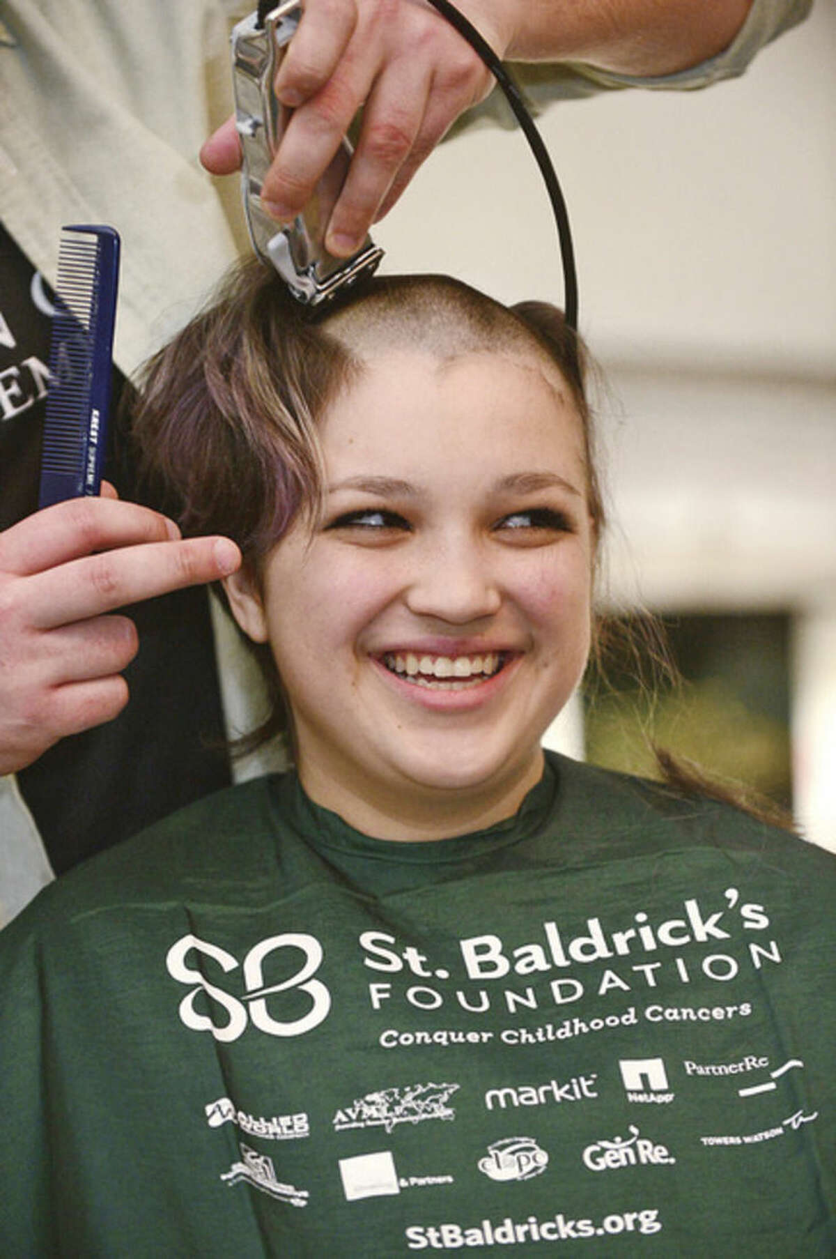 Hour photo / Erik Trautmann - Shannon Maguire gets her head shaved to raise money for cancer research. O'Neill's Irish Pub in Norwalk sponsored a St. Baldrick's Foundation signature head-shaving event to raise funds and awareness for lifesaving childhood cancer research on Saturday.