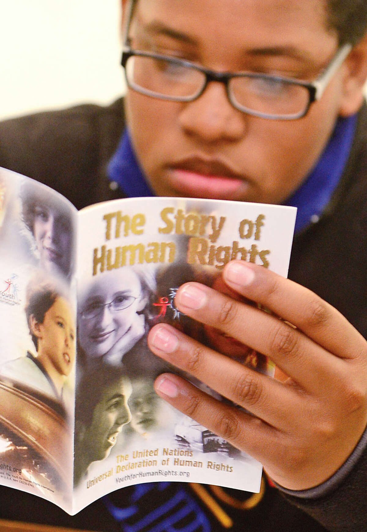 Hour photo / Erik Trautmann 7th grader Clive Bey reads about human rights during the Reerend Al Dancy's Pen or Pencil program at West Rocks Middle School that helps mentor 7th grade boys with discipline problems.