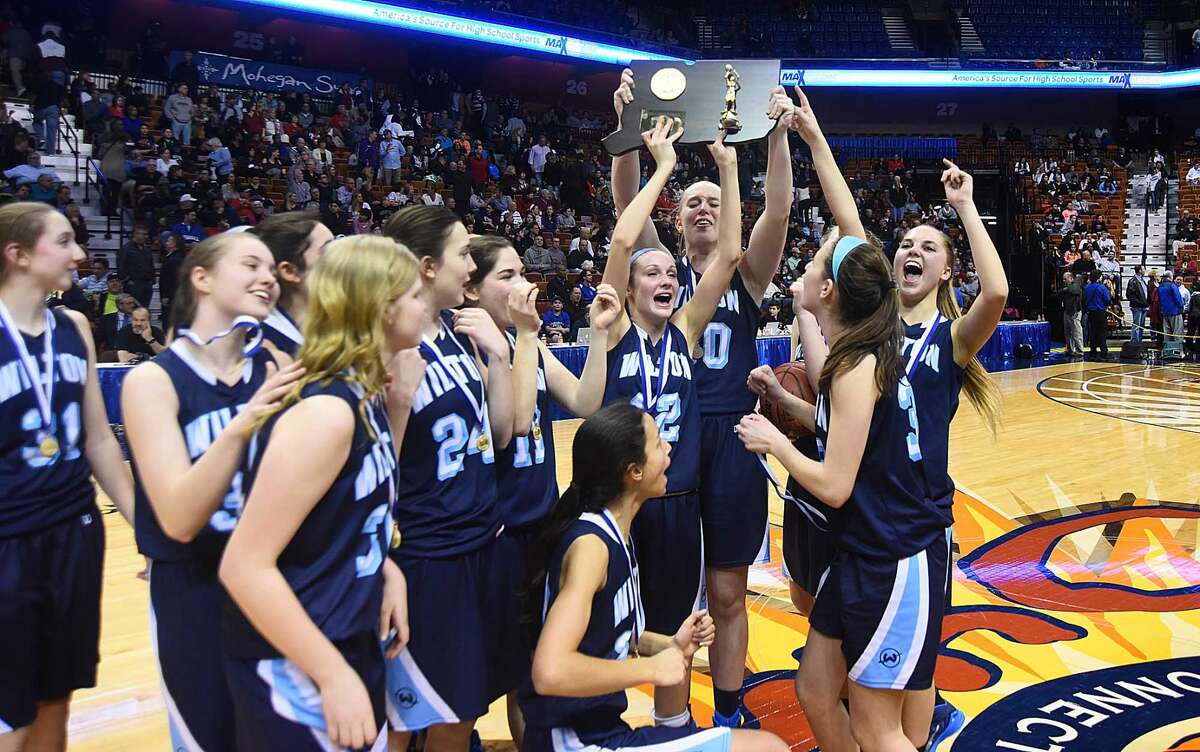 Hour photo/John Nash - The Wilton girls basketball team celebrates its 2015 Class LL state championship at the Mohegan Sun Arena.