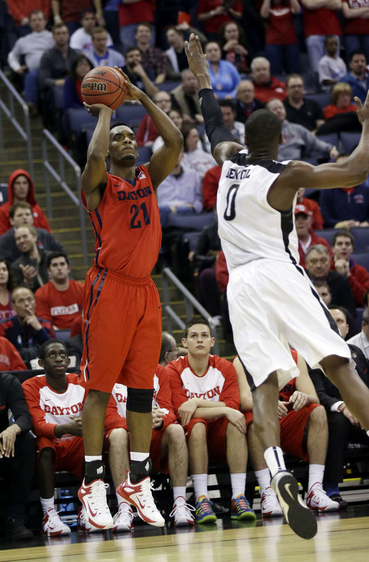 Dayton's Dyshawn Pierre (21) shoots over Providence's Ben Bentil (0) in the second half of an NCAA tournament college basketball game in the Round of 64 in Columbus, Ohio, Saturday, March 21, 2015. (AP Photo/Tony Dejak)