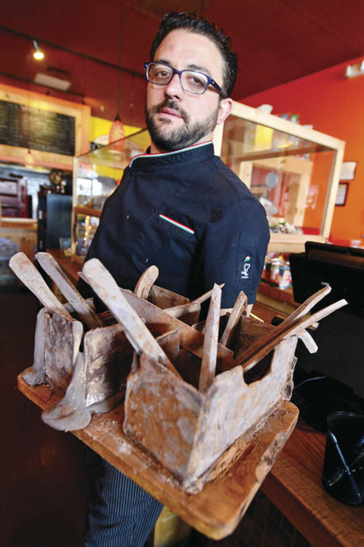 Hour photo / Erik Trautmann Romanacci's pizza restaurant owner, Graziano Ricci, makes hand-crafted chocolate tools, including hammers, wrenches, and bolts, that are a favorite among his customers.