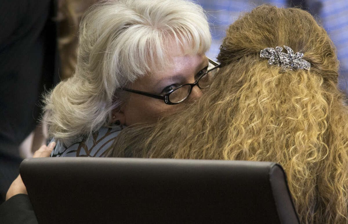Debra Milke, left, talks with her attorney, Lori Voepel during a hearing, Monday, March 23, 2015, in Marcopa County Superior Court in Phoenix. Judge Rosa Mroz dismissed murder charges Monday against Milke without prejudice and ordered a probation officer to remove a monitoring device from her ankle. Milke, 51, spent 23 years on Arizona death row for the December 1989 murder of her four-year-old son, Christopher. (AP Photo/The Arizona Republic, Mark Henle) MARICOPA COUNTY OUT; MAGS OUT; NO SALES