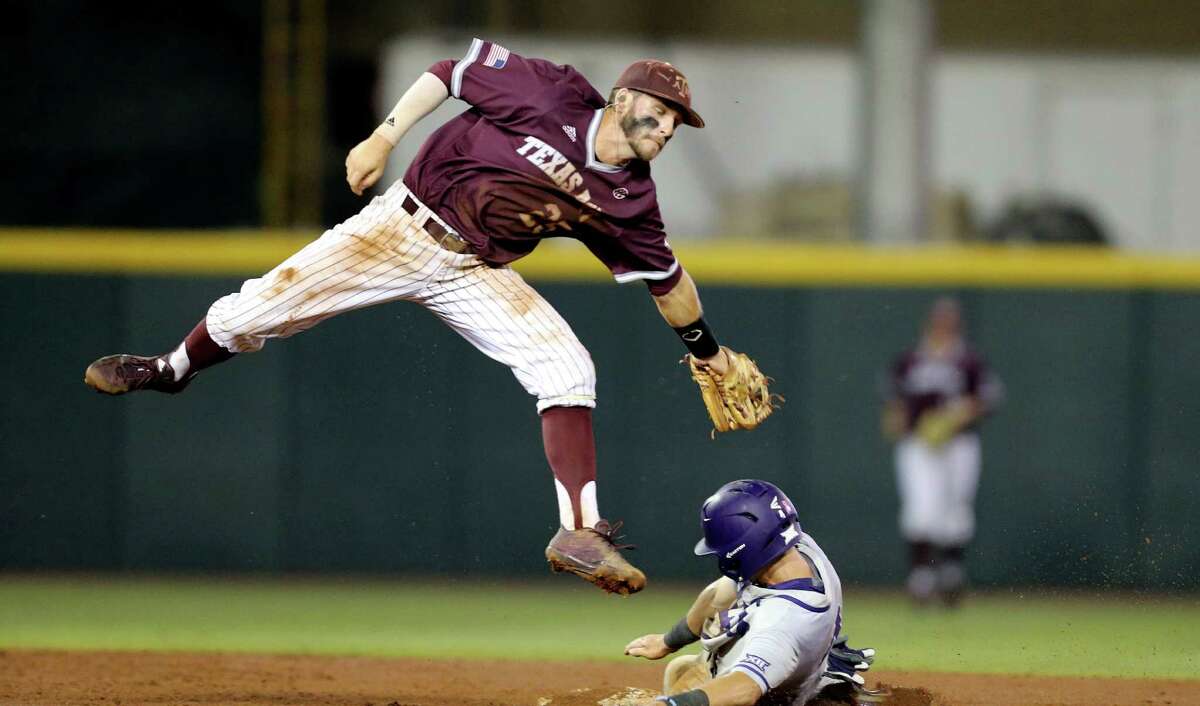 TCU's Cam Warner (4) steals second base as Texas A&M's Austin Homan (25) catches a late throw during the third inning of an NCAA Super Regional baseball tournament game, Friday, June 10, 2016, in College Station, Texas. (AP Photo/Sam Craft)