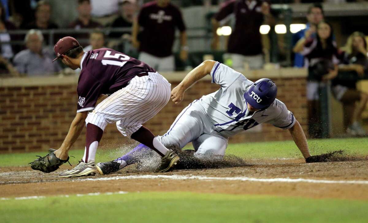 TCU's Luken Baker (19) is called safe at home after a wild pitch as Texas A&M's Brigham Hill (15) tries to apply a tag during the fifth inning of an NCAA Super Regional baseball tournament game, Friday, June 10, 2016, in College Station, Texas. (AP Photo/Sam Craft)