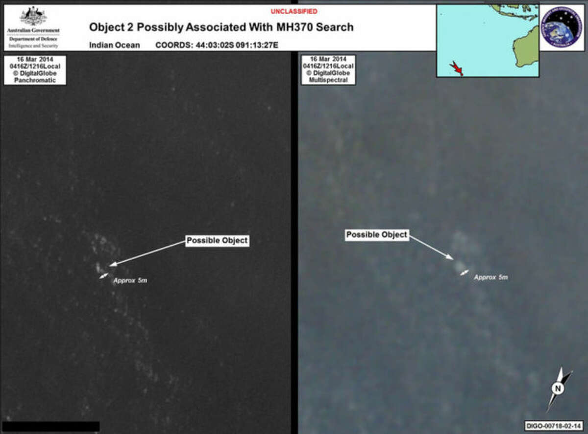 In this March 16, 2014 satellite imagery provided by Commonwealth of Australia - Department of Defence on Thursday, March 20, 2014, a floating object is seen at sea next to the descriptor which was added by the source. Australia's government reported Thursday, March 20, 2014 that the images show suspected debris from the missing Malaysia Airlines jetliner floating in an area 2,500 kilometers (1,550 miles) southwest of Perth Australia. (AP Photo/Commonwealth of Australia - Department of Defence)