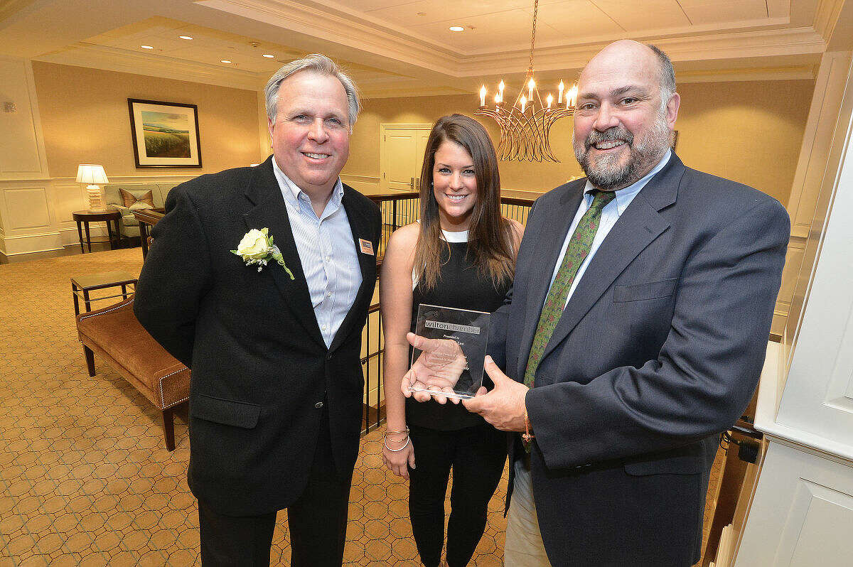 Wilton Chamber of Commerce President Patrick Russo, and Executive Director Janeen Leppert present Nicholas Lee, owner of Lee Horticultural Services, Business Person of the Year award during the chambers annual event at Rolling Hills Counrty Club.