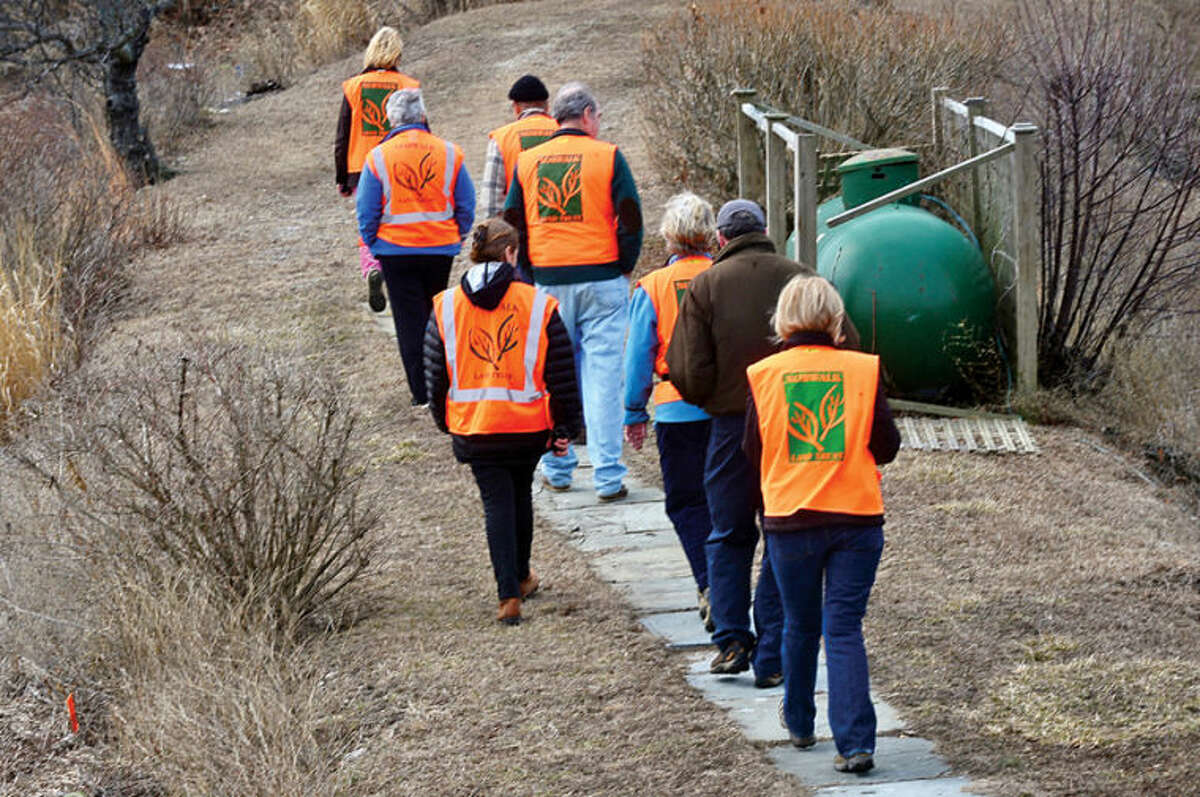 Hour photo / Erik Trautmann The tour group hikes to view Old Trolly peninsula at 2 Nearwater Lane as the Norwalk Land Trust hosts a tour of all of its properties Saturday morning.