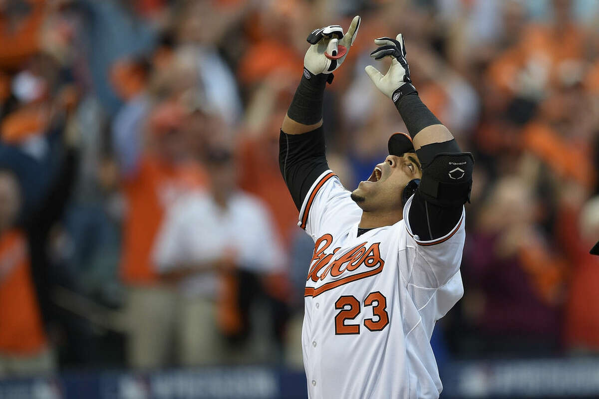 FILE - In this Oct. 2, 2014, file photo, Baltimore Orioles designated hitter Nelson Cruz gestures after his two-run home run in the first inning against the Detroit Tigers during Game 1 of baseball's AL Division Series in Baltimore. Major League Baseball heading towards opening day. From Cuba to Canada, from the Bay Area to the snow-besieged Northeast, great expectations abound. (AP Photo/Nick Wass, File)