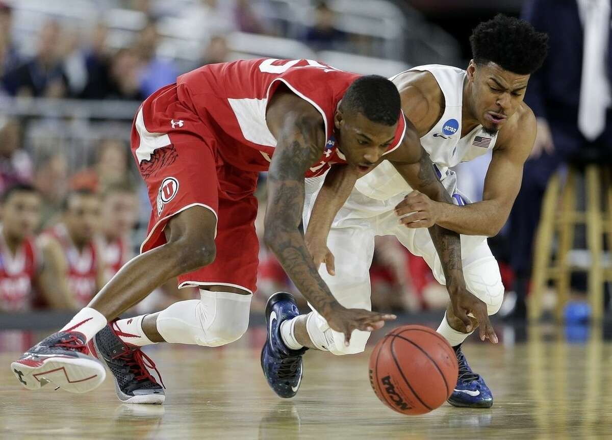 Utah's Delon Wright and Duke's Quinn Cook go after a loose ball during the second half of a college basketball regional semifinal game in the NCAA Tournament Friday, March 27, 2015, in Houston. (AP Photo/Charlie Riedel)