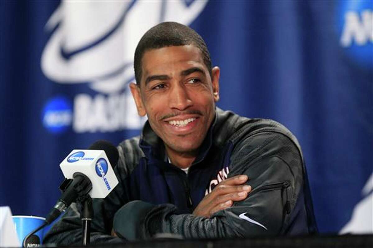 Connecticut players Kevin Ollie speaks during a media session during the the men's NCAA college basketball tournament at First Niagara Center in Buffalo, N.Y., Friday, March 21, 2014. (AP Photo/The Buffalo News, Harry Scull Jr.)