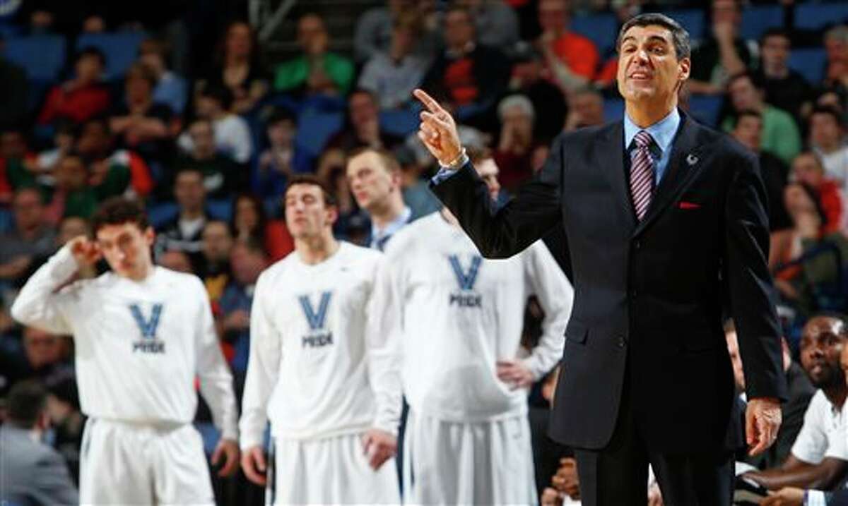 Villanova coach Jay Wright calls out to his team during the second half of a third-round game against Connecticut in the NCAA men's college basketball tournament in Buffalo, N.Y., Saturday, March 22, 2014. (AP Photo/Bill Wippert)