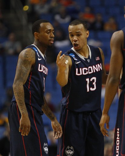 Connecticut's Shabazz Napier, right, is greeted by NBA