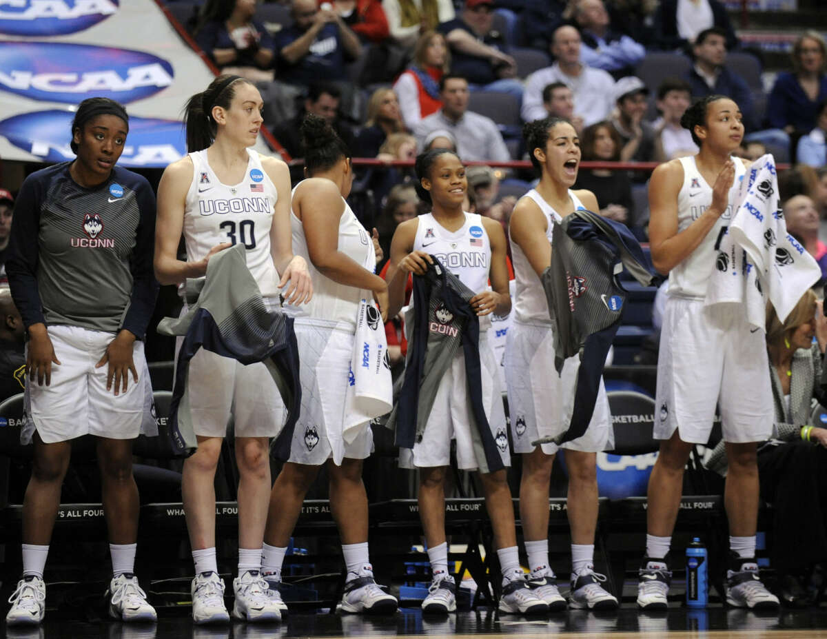 Connecticut players stand at the end of their 105-54 win over Texas in a women's college basketball regional semifinal game in the NCAA Tournament on Saturday, March 28, 2015, in Albany, N.Y. (AP Photo/Tim Roske)