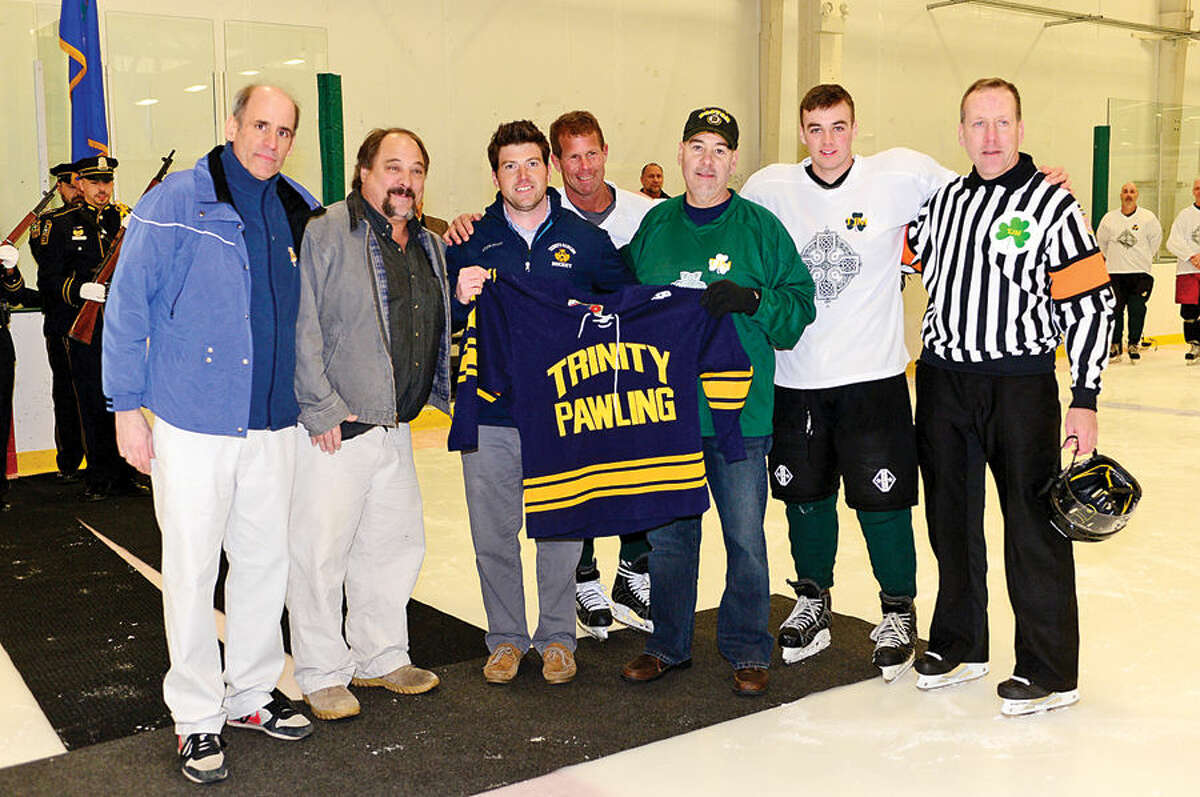 Hour photo / Erik Trautmann A group from Trinity Pawling hockey program honors retired NPD Lt. Timothy Murphy as the Norwalk Police Union holds a benefit hockey game for Murphy Saturday at SoNo Ice House. Murphy was diagnosed with cancer shortly after retiring