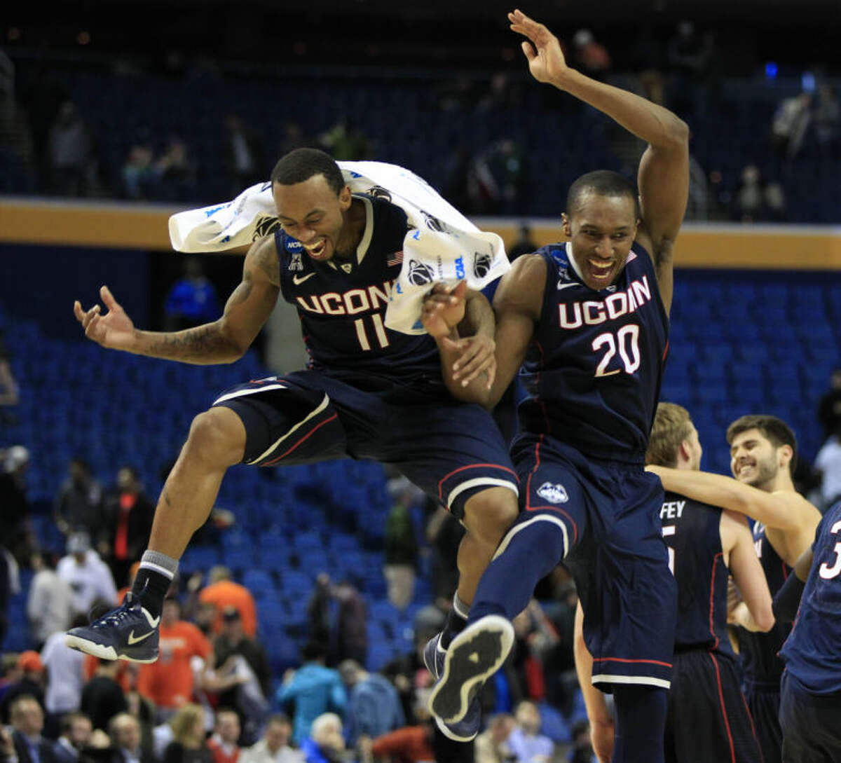UConn's Ryan Boatright (11) and Lasan Kromah (20) celebrate their team's 77-65 victory over Villanova in the third-round game in the men's NCAA college basketball tournament at the First Niagara Center, Sunday, March 23, 2014. (AP Photo/The Buffalo News, Harry Scull Jr.)