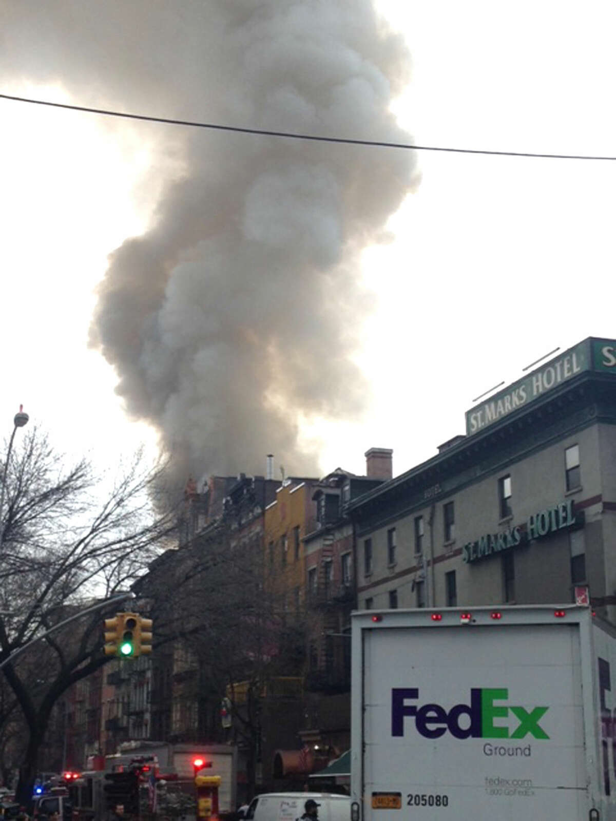 Smoke billows from a building in New York's East Village neighborhood at the scene of a large fire and a partial building collapse. (AP Photo/Jonathan Lemire)