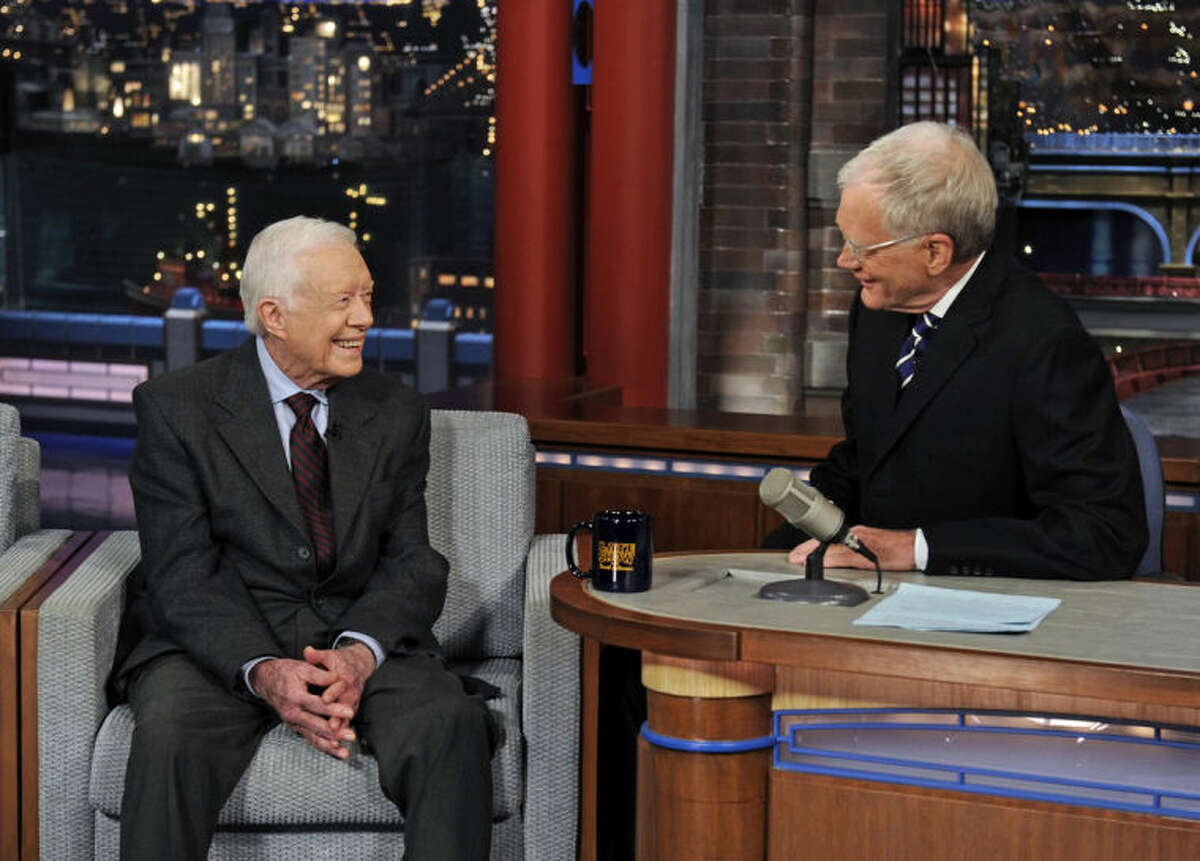 In this photo provided by CBS, former President Jimmy Carter, left, talks with David Letterman on "Late Show with David Letterman," Monday March 24, 2014. Carter said during the broadcast that the Crimean annexation was "inevitable" because Russia considers it to be part of their country and so many Crimeans consider themselves Russian. But he says Russian President Vladimir Putin shouldn't be permitted to go any further. (AP Photo/CBS, Jeffrey R. Staab)