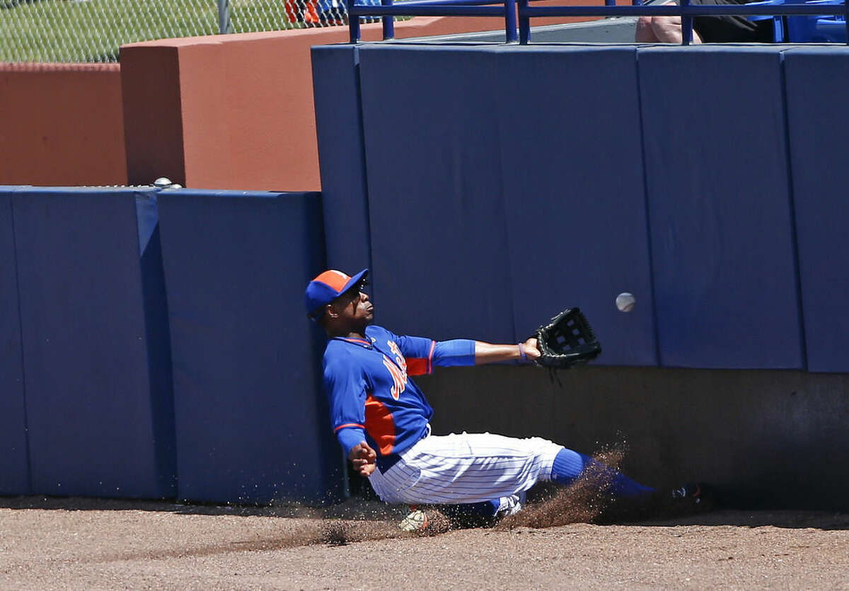 New York Mets right fielder Curtis Granderson (3) can't reach a foul ball off the bat of Miami Marlins' Martin Prado in the fourth inning of an exhibition spring training baseball game Monday, March 30, 2015, in Port St. Lucie, Fla. (AP Photo/John Bazemore)