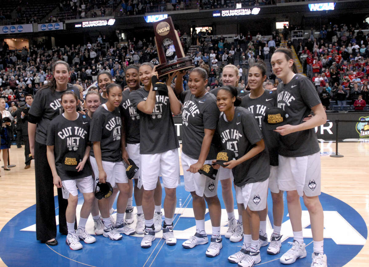 Connecticut players pose with the trophy after their 91-70 win over Dayton in a regional final game in the NCAA women's college basketball tournament Monday, March 30, 2015, in Albany, N.Y. (AP Photo/Tim Roske)