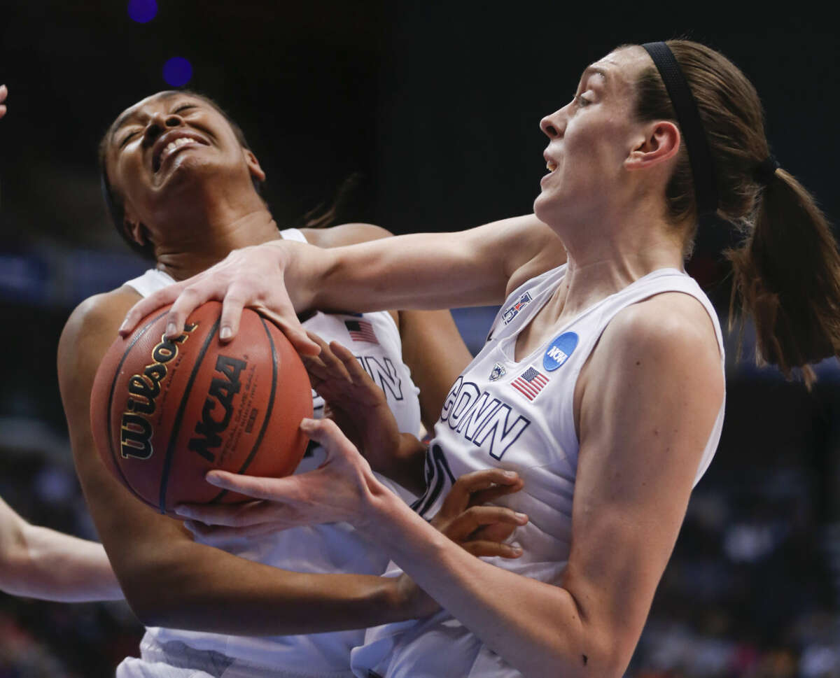 Connecticut players Morgan Tuck, left, and Breanna Stewart grab a rebound during the first half of a regional final game against Dayton in the NCAA women's college basketball tournament Monday, March 30, 2015, in Albany, N.Y. (AP Photo/Mike Groll)