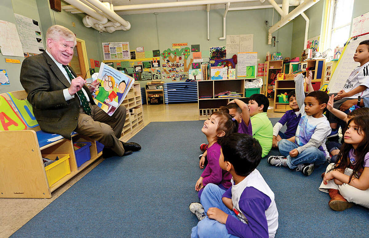 Hour photo / Erik Trautmann Interim Superintendent James A. Connelly reads a book to preschool children at the Norwalk Head Start School Readiness Program at Ben Franklin Center as part of Week of the Young Child.