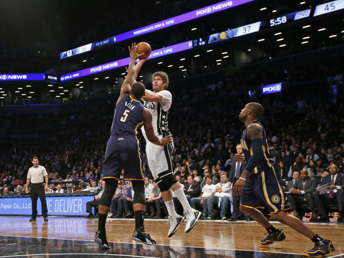 Brooklyn Nets center Brook Lopez (11) shoots over Indiana Pacers forward Lavoy Allen (5) in the first half of an NBA basketball game at the Barclays Center, Tuesday, March 31, 2015, in New York. (AP Photo/Kathy Willens)