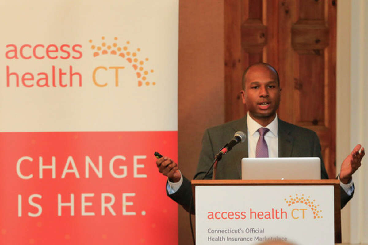Chris Palermo / Hour Photo. Access Health Outreach Coordinator Loo Goodall address the crowd during the overview of the healthcare reform put on by Access Health CT at City Hall Thursday night.
