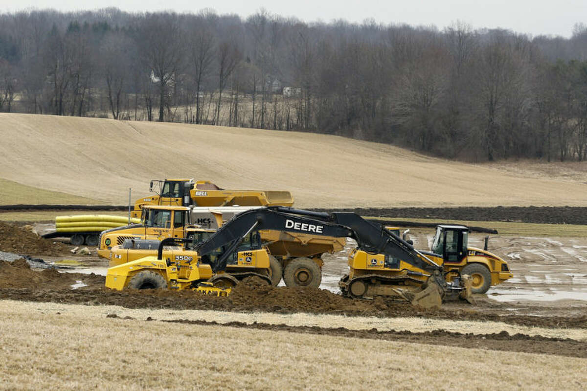 In this March 20, 2014 photo, equipment is parked at a gas well drilling site in Pulaski, Pa. The gas drilling company Hilcorp that is working the well has asked state officials to invoke a 1961 law in the rural area and allow Utica Shale well bores under the property of four landowners who haven?’t signed leases. (AP Photo/Keith Srakocic)