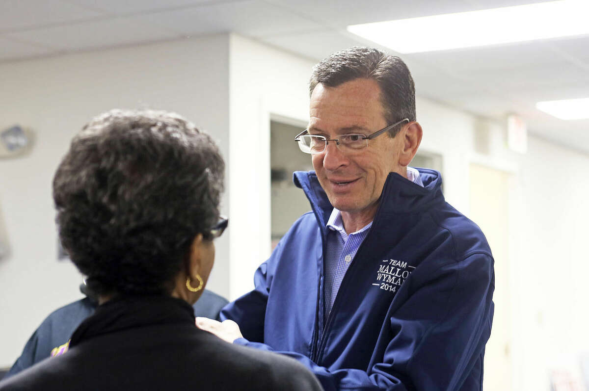 Governor Malloy speaks to an attendee during a stop Stamford Housing stop at 1250 Summer Street in Stamford Saturday, Nov. 1. Hour Photo / Danielle Calloway