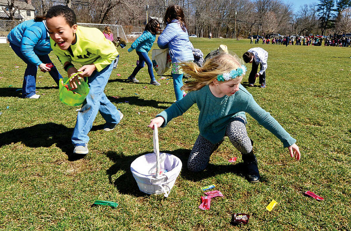 Hour photo / Erik Trautmann Nearly two hundred children take part in the 64th annual Greens Farms Volunteer Fire Company Easter Egg Hunt at Long Lots School School Saturday